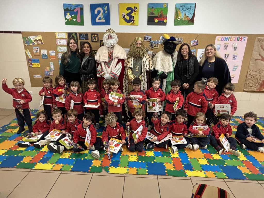 Grupo de Infantil posando con los Reyes Magos y sus maestras en el aula