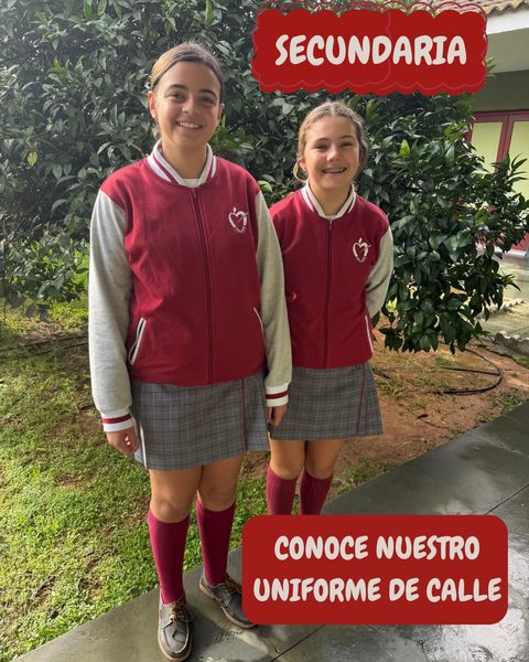 Dos alumnas de Secundaria con la chaqueta granate de mangas claras, falda de cuadros y calcetín alto granate